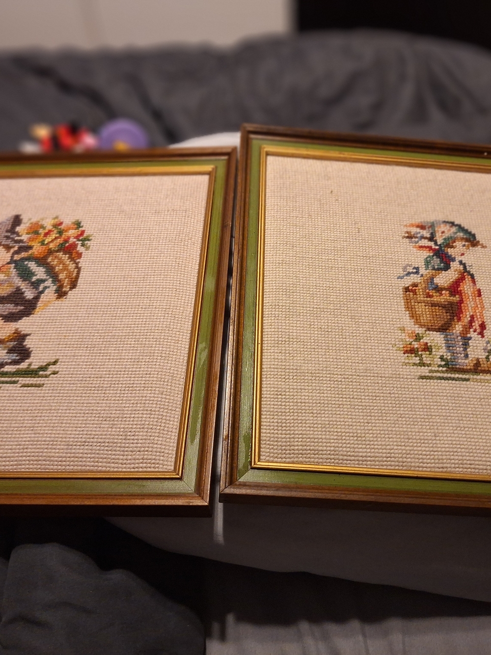 a pair of vintage Hummel framed needlepoint pictures featuring a boy a Girl